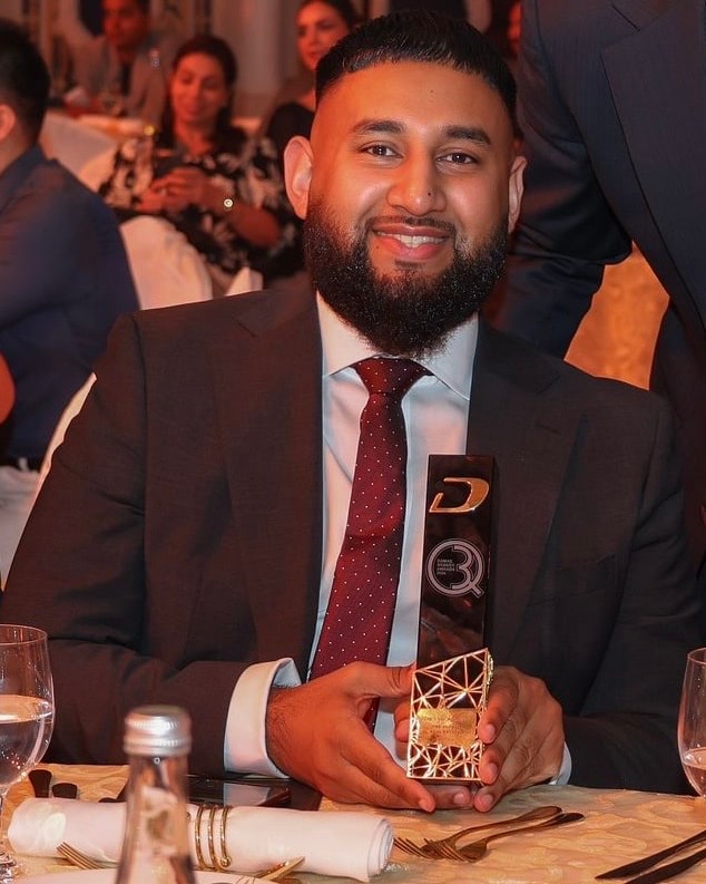 Tazz Miah receiving the DAMAC Broker Awards trophy